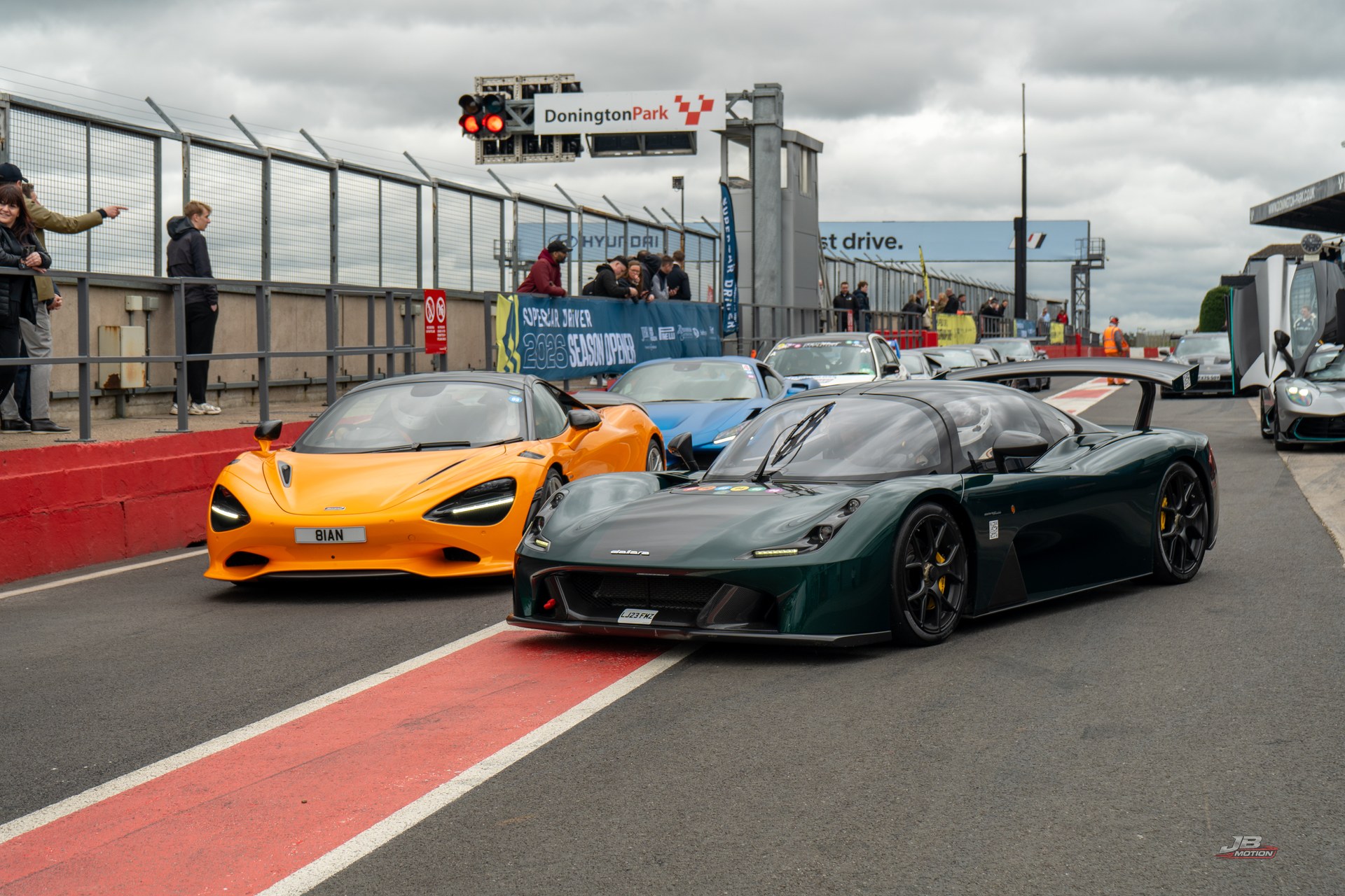 Supercars lined up on the pit lane at Donington Park, photographed by JB Motion